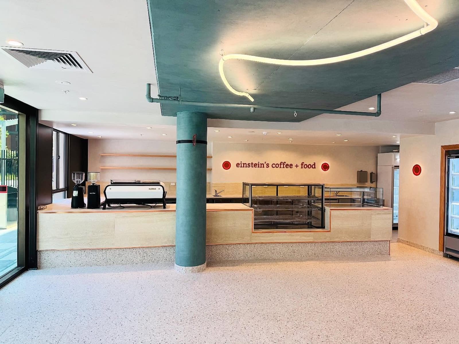 Commercial cafe fit-out with a painted feature ceiling and timber servery counters